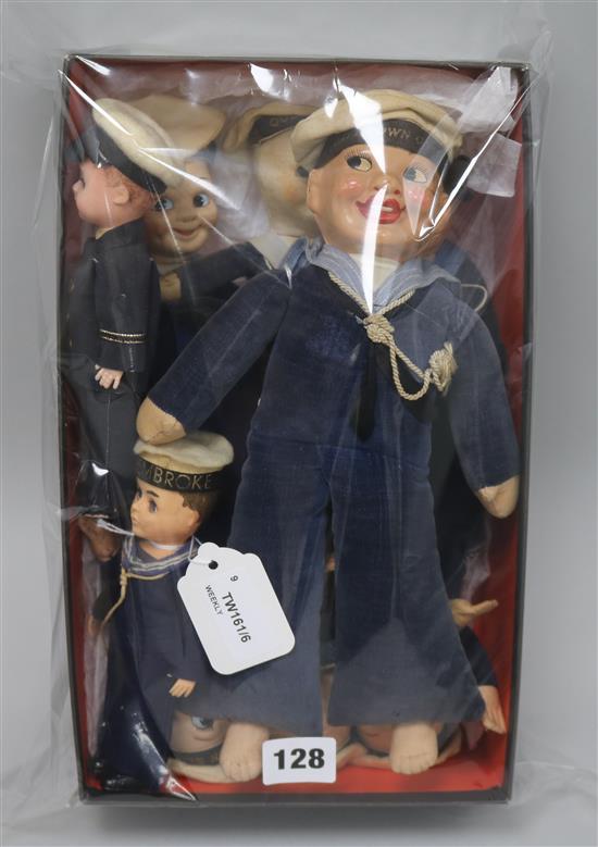 A collection of seven soft-bodied souvenir sailor dolls and two celluloid examples